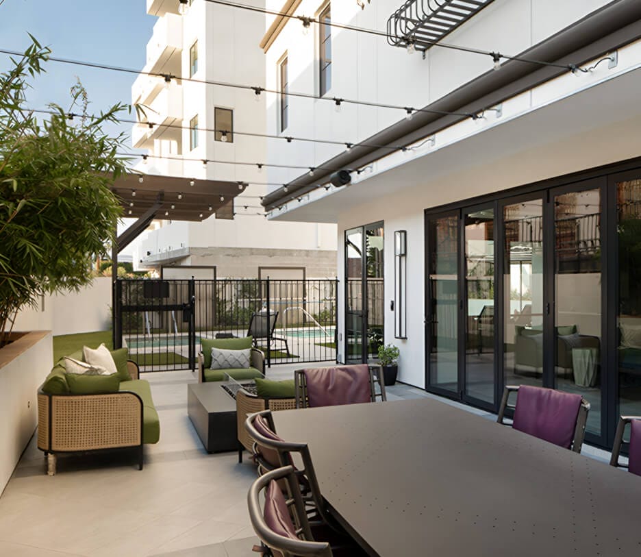 Modern outdoor patio area with furniture.