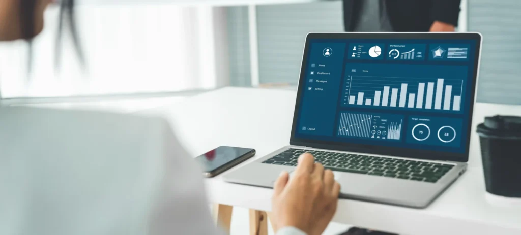 a businesswoman in her office analyzes marketing data on a lead tracking tool displayed on her laptop