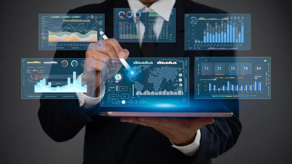 Businessman holding a tablet, reviewing lead tracker management software on a sleek futuristic digital dashboard. The screen displays interactive visual analytics, including colorful bar graphs, line charts, performance metrics, and real-time financial data, all set against a high-tech interface.