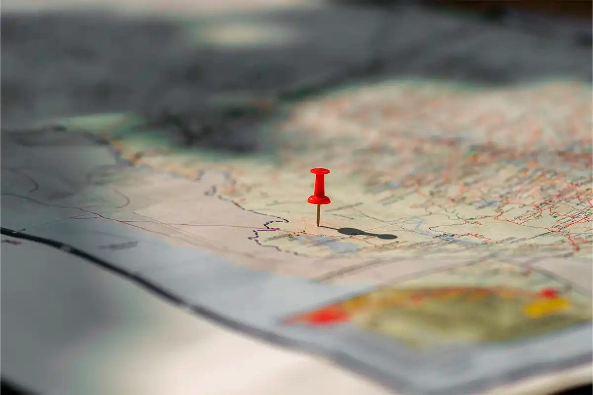 a red pushpin placed on a map, symbolizing a marked location product of the work of a google maps marketing agency with off page seo services