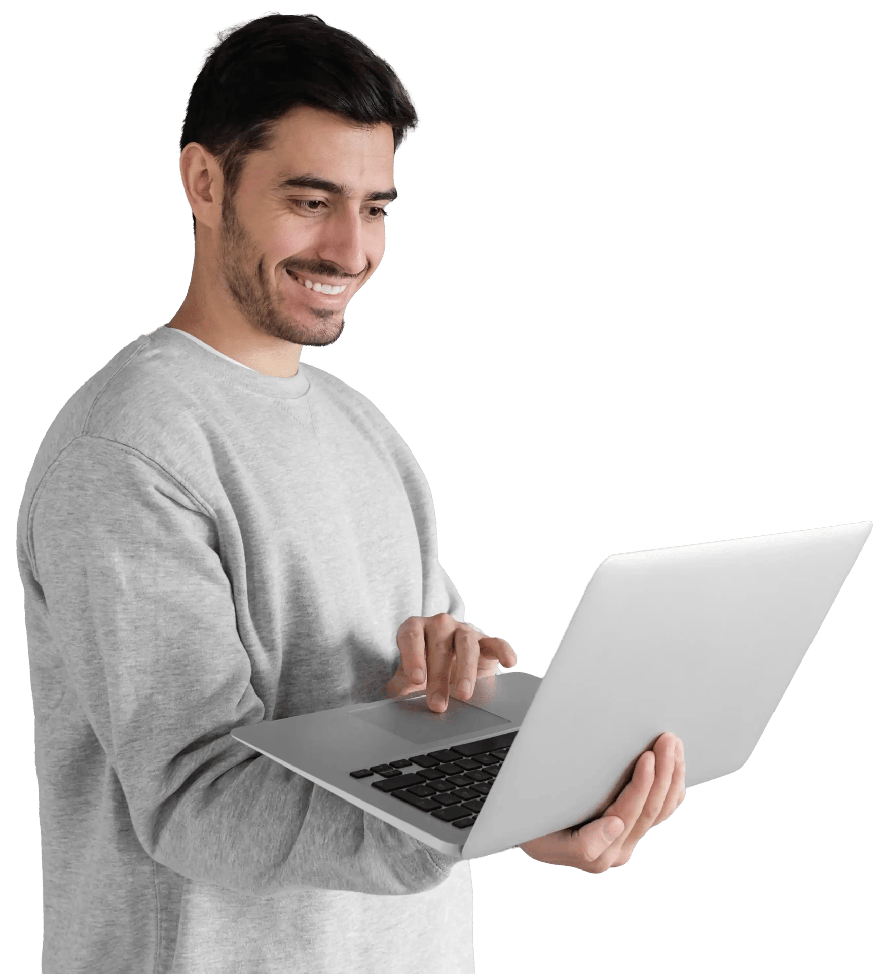 portrait of young man in gray sweatshirt standing with a laptop